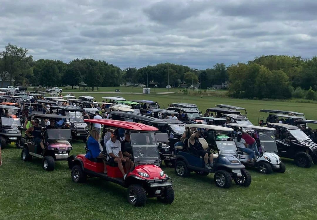 golf carts lined up for the cart crawl for charity